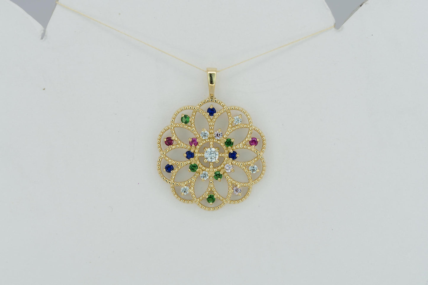 14k gold pattern pendant with multicolor gemstones