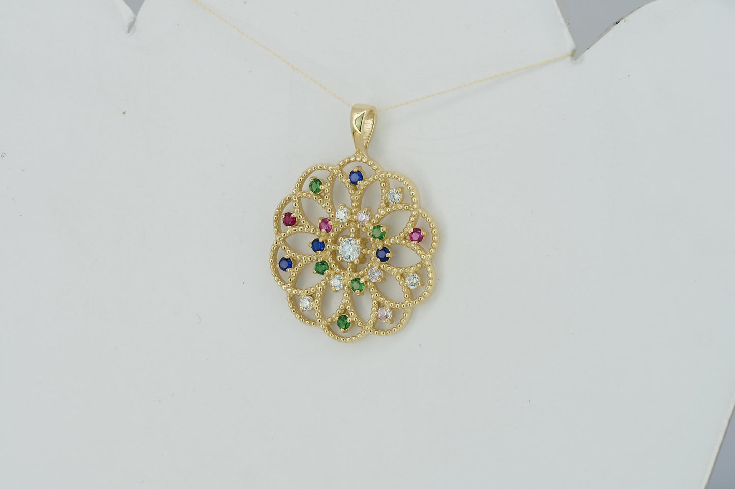 14k gold pattern pendant with multicolor gemstones