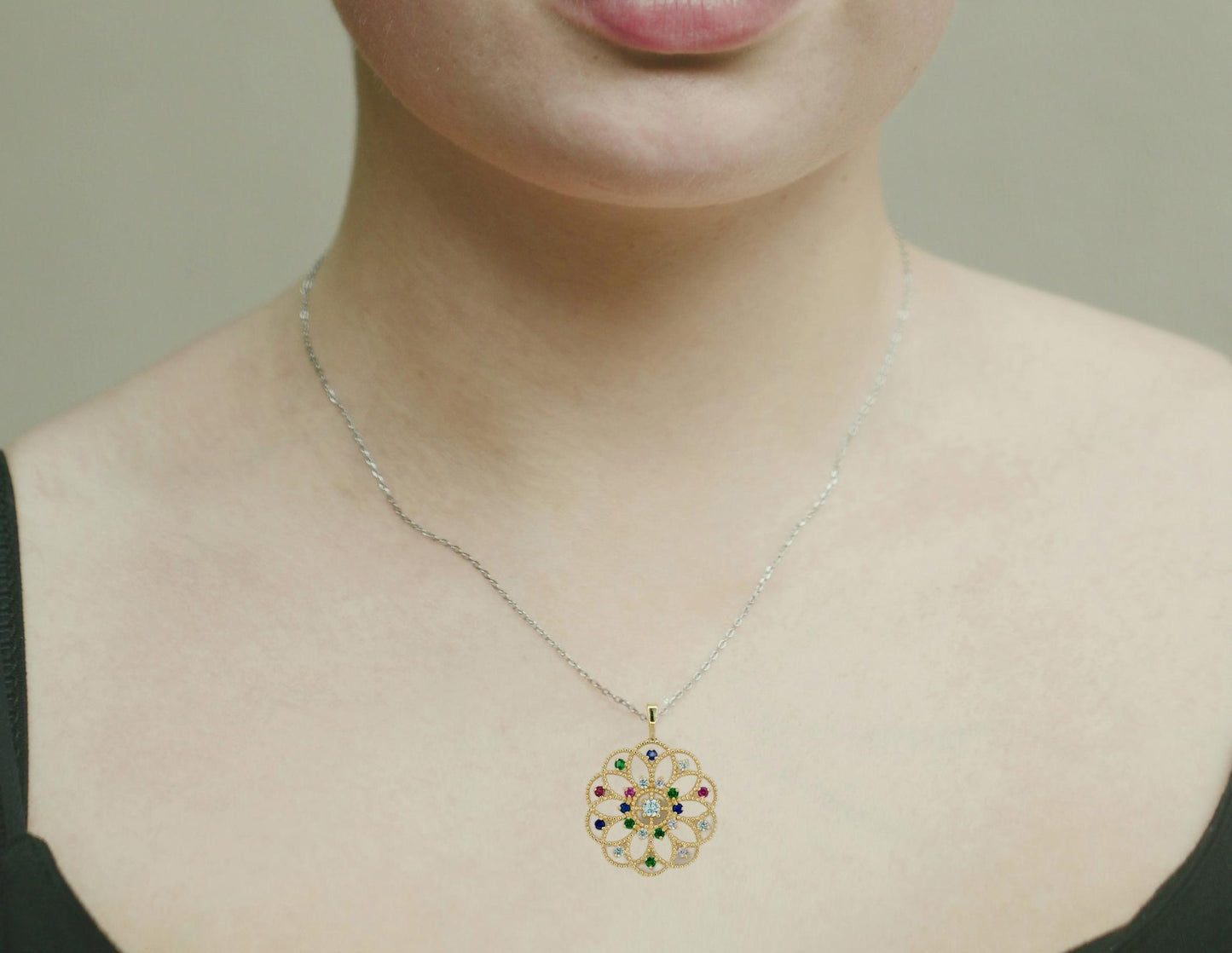 14k gold pattern pendant with multicolor gemstones