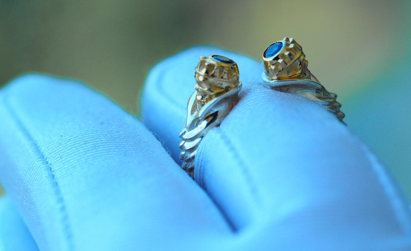 Skull ring with blue sapphires in 14k gold