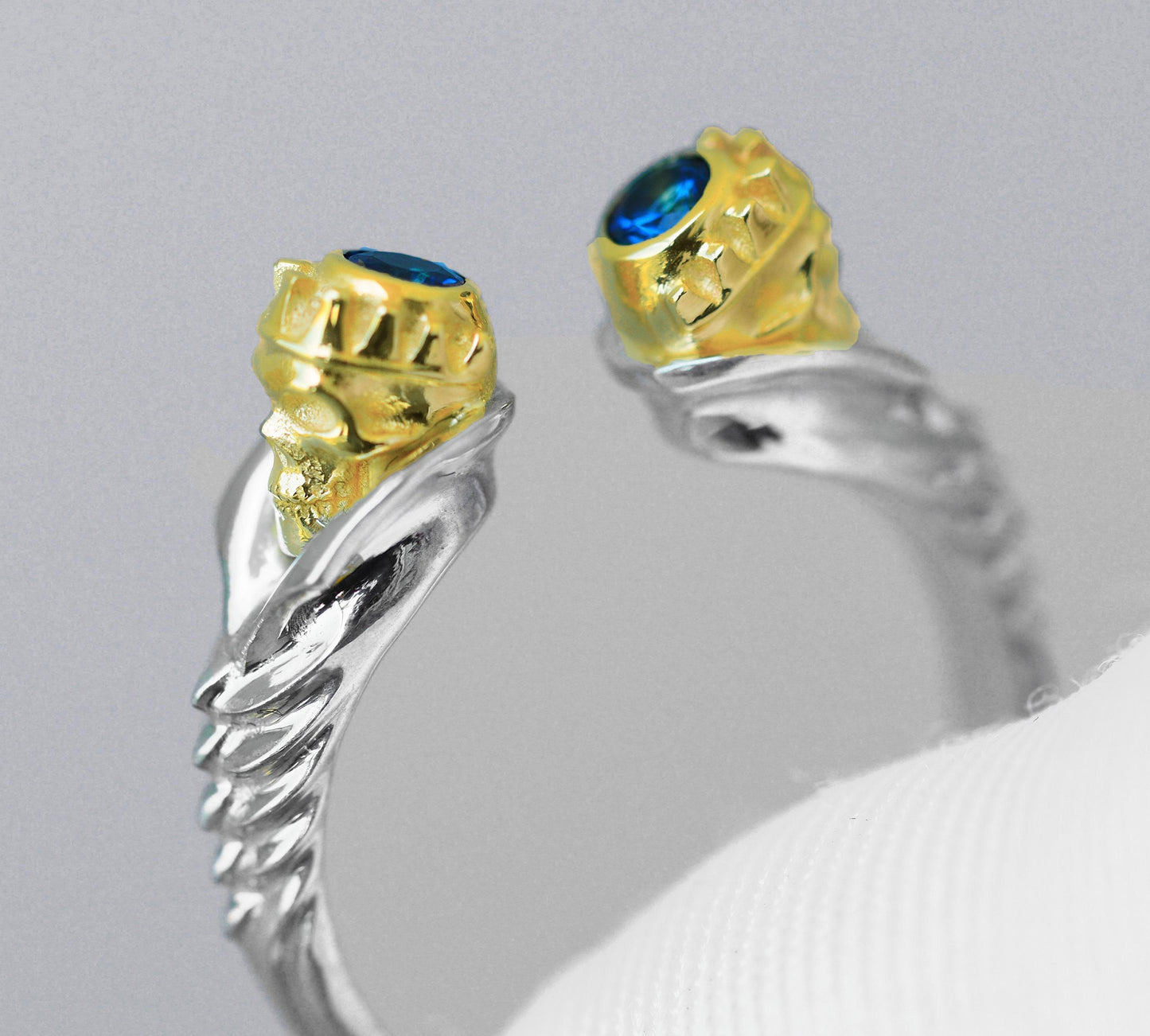 Skull ring with blue sapphires in 14k gold