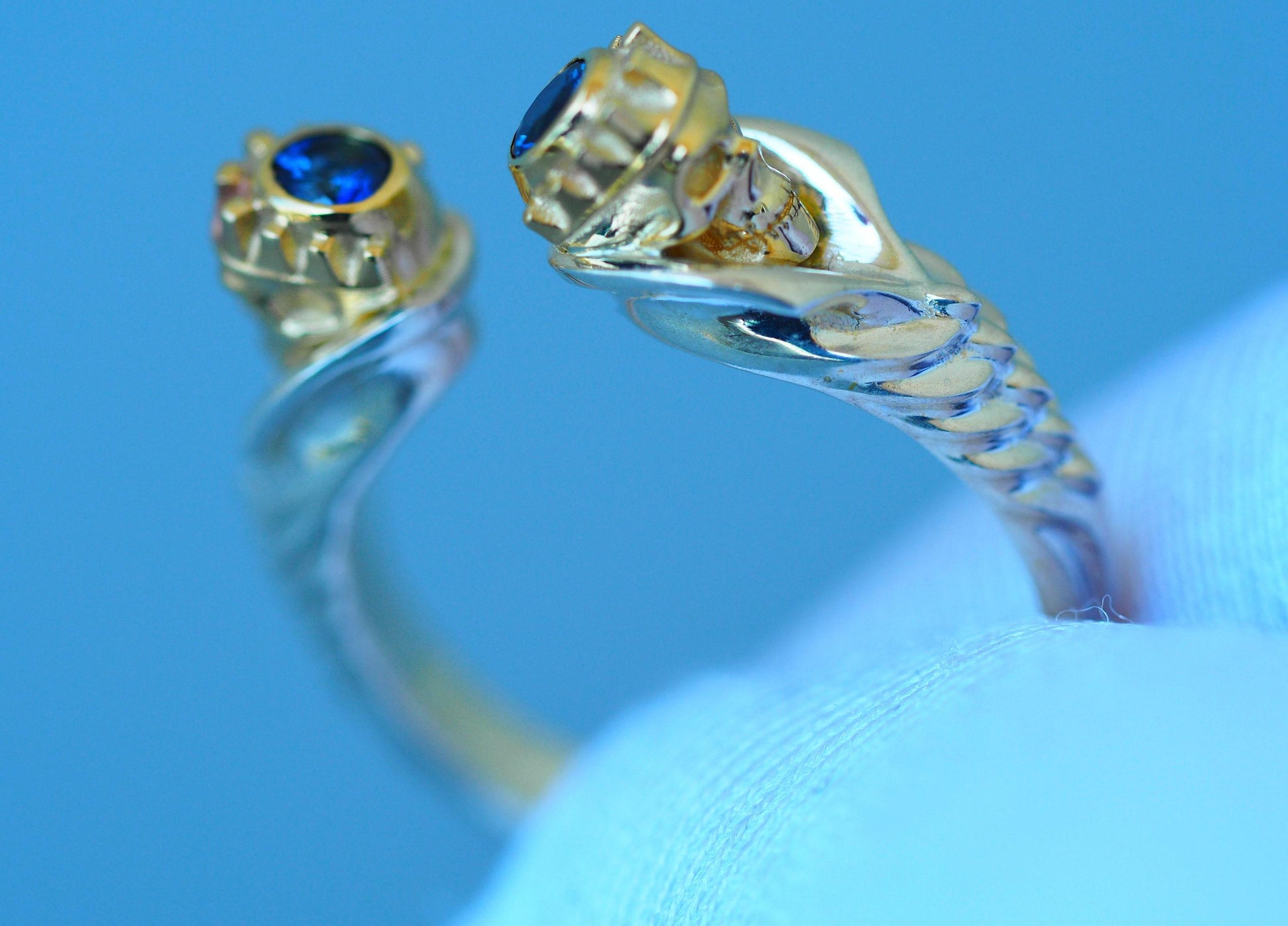 Skull ring with blue sapphires in 14k gold