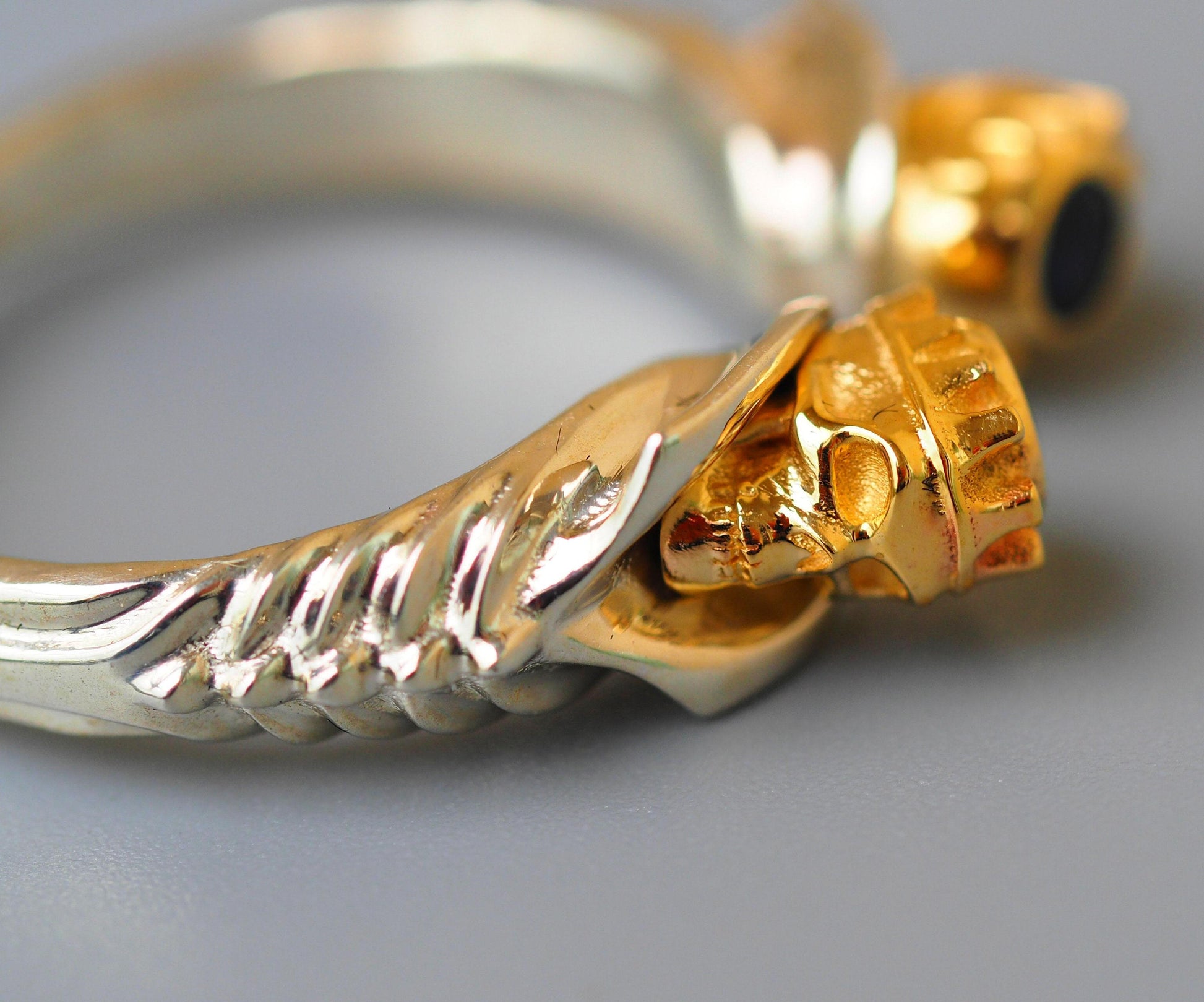 Skull ring with blue sapphires in 14k gold