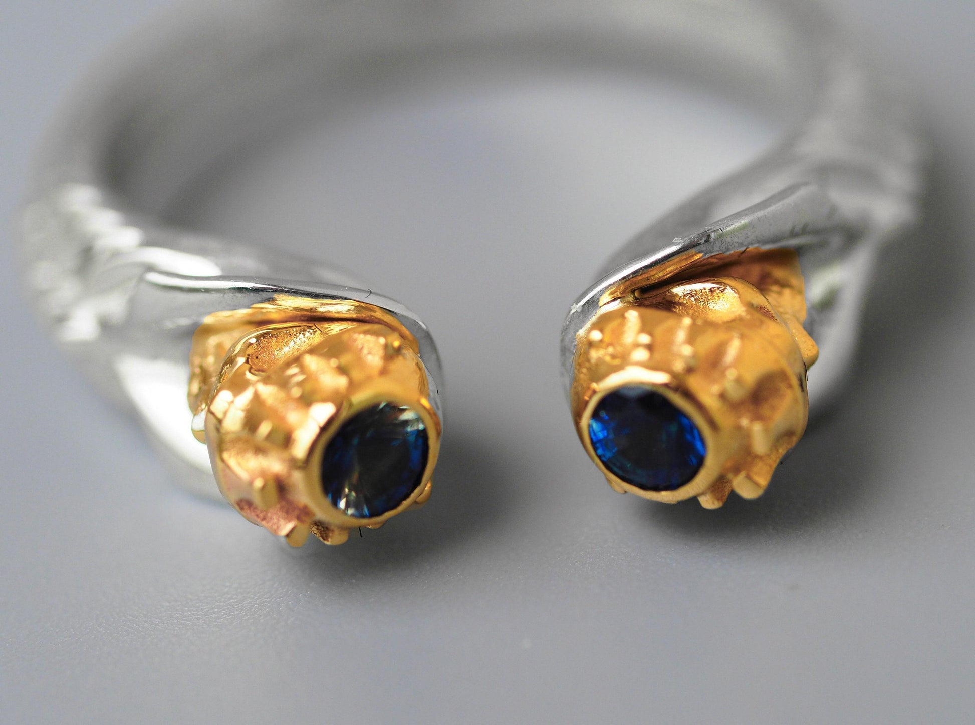 Skull ring with blue sapphires in 14k gold