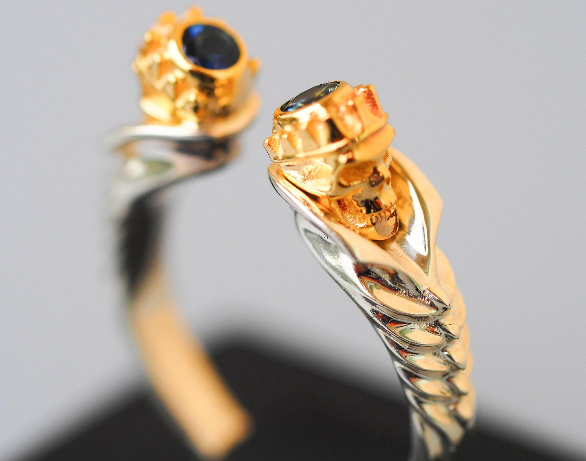 Skull ring with blue sapphires in 14k gold