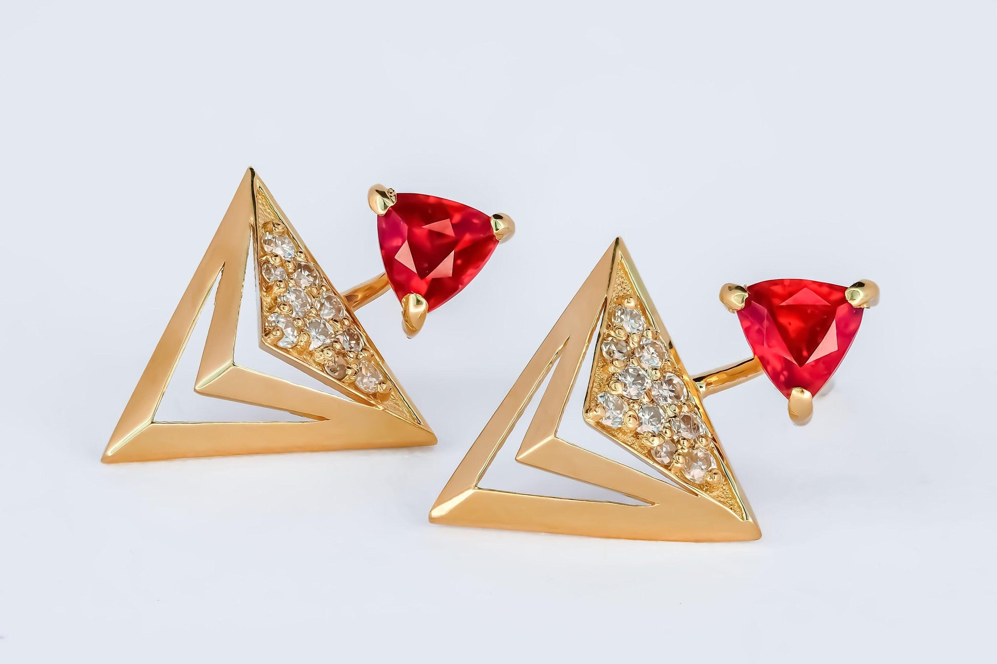 Trillion cut ruby stud earrings in 14k solid gold