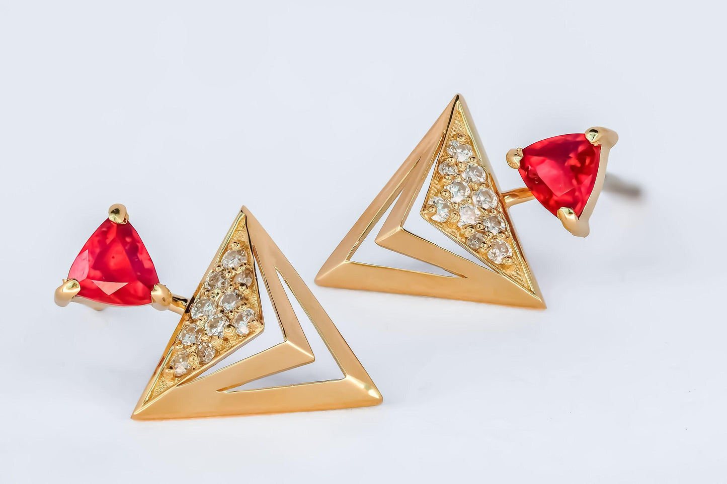 Trillion cut ruby stud earrings in 14k solid gold