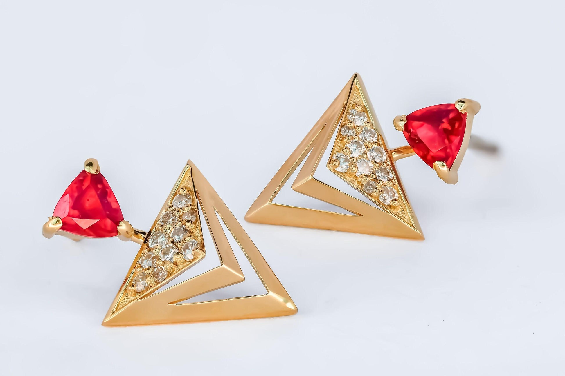 Trillion cut ruby stud earrings in 14k solid gold